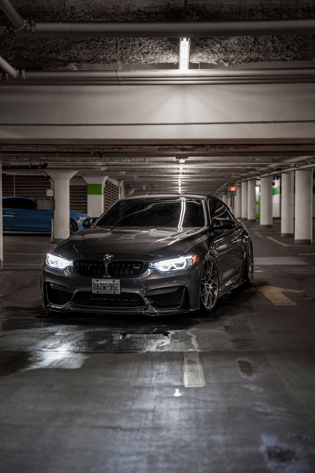 Black BMW with tinted windows in a parking garage